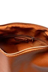 Bolso de hombro tipo hobo, confeccionado en cuero texturizado color marrón. Presenta un diseño minimalista con cierre superior, correa ajustable y detalle de tiras decorativas en el lateral.