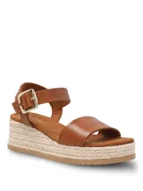 Sandalias de plataforma de yute Hush Puppies modelo Lili, color marrón, con tira ancha en el empeine, tira ajustable en el tobillo con hebilla dorada y suela dentada.