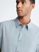 Camisa celeste de manga corta Calvin Klein, con cierre de botones y logo bordado en el pecho.