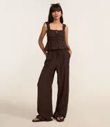 Pantalón recto de mujer confeccionado en viscosa con textura arrugada. Presenta cintura elástica con lazo de ajuste y diseño fluido.