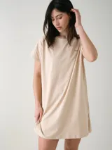 Camisón blanco de algodón, de corte holgado, manga corta y largo por encima de las rodillas. Presenta una pequeña estampa localizada en el pecho y aberturas en los laterales.