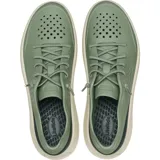 Championes Crocs Inmotion Heel Block Pacer color verde militar, con detalles en negro en el talón y suela beige. Incorporan tecnologías LiteRide y Free Feel Technology, con parte superior perforada, cordones elásticos y diseño deportivo.