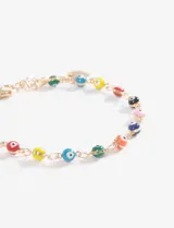 Pulsera dorada con cadena de eslabones y dijes de ojitos turcos de colores.