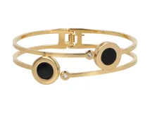 Pulsera rígida dorada de acero con doble aro, apliques circulares de esmalte negro y strass.