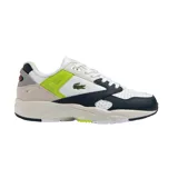 Championes Lacoste Storm 96 Lo, blancos con detalles en azul marino y verde lima. Presentan el logo de la marca en el lateral y suela gruesa.