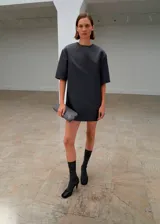 Vestido corto de diseño recto y cuello redondo, con mangas cortas. Confeccionado en tejido satinado con forro interior y cierre de cremallera en la parte posterior.