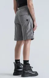 Bermuda cargo color gris oscuro (carbón), de corte recto y largo hasta la rodilla, con cinturón de cinta negra ajustable con hebilla de plástico. Presenta bolsillos laterales y bolsillos cargo con solapa en las piernas.