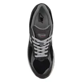 Championes urbanos New Balance modelo 2002R, color gris oscuro con detalles en negro. Confeccionados en una combinación de gamuza y malla, cuentan con el logo N en los laterales, tecnología N-ergy en la entresuela y cordones grises.
