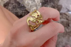 Anillo ancho de diseño orgánico y calado, con apariencia de red o magma solidificado.