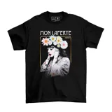 Remera negra de algodón con estampa frontal de la cantante Mon Laferte con una corona de flores, enmarcada en un recuadro dorado.