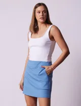 Minifalda azul de gabardina elastizada con pretina ancha elastizada, bolsillos delanteros y short interno.