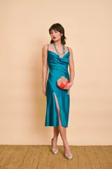 Vestido midi de satén turquesa, con escote drapeado, tirantes finos, tajo lateral en la pierna y detalle de botones forrados en el lateral.