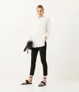 Pantalón de sastrería negro, con cintura elástica en la espalda, bolsillos delanteros y aberturas laterales en la basta.