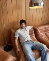 Remera gris de corte regular con estampa gráfica en la espalda que presenta un collage de estilo cómic con la palabra 'BO!' en el centro.