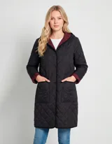 Campera reversible de corte largo con diseño capitoneado. Un lado presenta un tono verde oliva y el otro un tono negro, ambos con cierre frontal mediante botones a presión y bolsillos laterales.