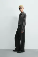 Camisa de corte relajado confeccionada en tejido fluido de viscosa, con cuello solapa, manga larga con puños abotonados y cierre frontal de botones. Presenta un estampado con efecto lavado.