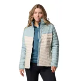 Campera acolchada Columbia modelo Powder Pass, con diseño bicolor en tonos celeste y beige. Presenta cuello alto, cierre frontal completo, mangas largas y bolsillos laterales con cierre.