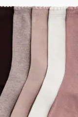 Pack de cinco pares de medias de caña media, confeccionadas en tejido de punto fino. Los colores incluidos son marrón oscuro, gris melange, rosa pálido, blanco y rosa viejo. El borde superior de todas las medias es elástico con un ribete festoneado.