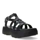 Sandalias tipo franciscana de cuero negro con plataforma dentada y cierre de hebilla lateral.