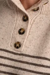 Sweater de lana y nylon, color beige jaspeado con rayas horizontales marrones oscuras. Presenta cuello alto con abertura frontal abotonada con tres botones marrones.