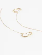 Aros de acero quirúrgico hipoalergénico dorados con forma de medialuna y cadena colgante.