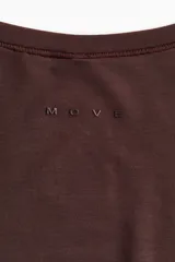 Top de deporte cruzado en modal suave, de manga larga, con escote en V pronunciado y tiras para anudar en la cintura.