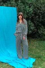 Pantalón de fibrana con diseño de rayas verticales en tonos rojos y blancos, de corte amplio y fluido.