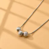 Collar de plata 925 con cadena veneciana y dije colgante compuesto por tres esferas estriadas.
