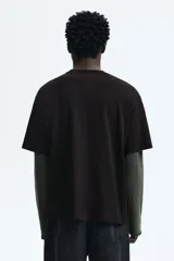 Remera de algodón marrón oscuro con cuello redondo y mangas cortas. Presenta un estampado frontal con gráficos de básquetbol y texto 'Street Hoops 95'.