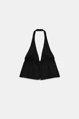 Top negro de cuello halter y escote en V pronunciado, confeccionado en popelina con frunces ajustables mediante cordón en el pecho y cierre frontal con lazada.