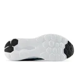 Championes New Balance modelo 411, color azul oscuro con detalles en turquesa y logo "N" en el lateral. Suela blanca gruesa y amortiguada.