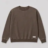 Buzo de cuello redondo con efecto lavado, de corte oversize y mangas largas con puños acanalados.