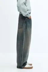 Pantalón de jean celeste con efecto lavado, corte holgado de cadera a bajo con piernas redondeadas extraanchas y pliegues al tobillo.