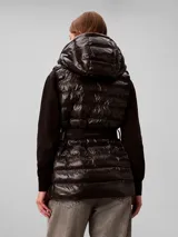 Chaleco puffer liviano marca Calvin Klein color negro, con diseño acolchado, capucha, cierre frontal y cinturón elástico con hebilla a presión y logo de la marca.