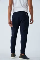 Pantalón de jogging gris melange, de felpa, con puños y bolsillos con cierre.