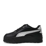 Championes urbanos Puma modelo Karmen II Idol Metallic, color negro con detalle de franja lateral plateada metalizada. Presentan una suela de plataforma robusta y diseño de caña baja.