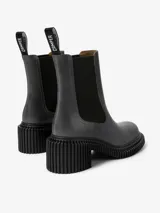 Bota de media caña color gris oscuro, confeccionada en piel vacuna, con paneles elásticos laterales, tirador trasero y suela XL EXTRALIGHT. Tiene un tacón de 7 cm con diseño acanalado.
