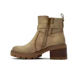 Bota de caña corta color beige, confeccionada en material tipo gamuza, con taco cuadrado de madera y suela track. Presenta una tira decorativa con hebilla metálica en el tobillo y paneles elásticos laterales.