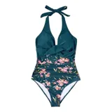 Malla entera de color verde oscuro, combinada con un diseño floreado en la parte inferior. Presenta escote halter cruzado y fruncidos en la zona del abdomen.