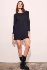 Vestido corto negro de viscosa con elastano, corte recto y mangas largas.