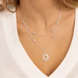 Collar doble de plata 925 con dije de sol y topacios blancos.