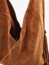 Cartera de gamuza negra con diseño amplio y silueta relajada, decorada con flecos laterales. Incluye un asa superior integrada, correa desmontable y un pequeño monedero frontal con cierre.