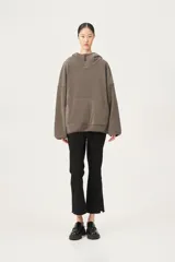 Hoodie de silueta amplia, color gris topo, con capucha y cierre corto en el cuello. Presenta un bolsillo canguro frontal.