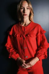 Campera de jean blanca con volados en el frente y las mangas, confeccionada en algodón y lino.