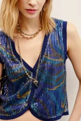 Chaleco sin mangas de viscosa y poliamida con apliques de lentejuelas brillantes, cuello en V y diseño con estampado animal print en tonos azules y dorados.