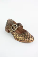 Zapato estilo Mary Jane confeccionado en cuero trenzado con diseño de damero en blanco y negro. Presenta una tira con hebilla circular en el empeine y un taco bajo cuadrado.