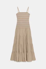 Vestido midi color beige, con cuerpo ajustado de nido de abeja elástico con bordados a contraste y falda larga en capas. Presenta escote recto y tirantes finos ajustables.