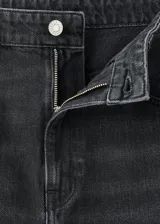 Pantalón de jean negro de tiro medio, con diseño estilo barrel o balloon, corte amplio y cinco bolsillos.