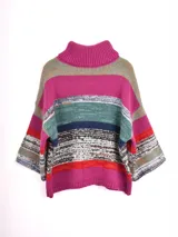 Polera de punto multicolor con cuello alto, mangas 3/4 y diseño de rayas horizontales. Las rayas combinan fucsia, verde, azul marino, blanco con detalles en negro y rojo.