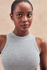 Musculosa de tejido acanalado con acabado brillante, de corte ajustado al cuerpo y cuello redondo alto.